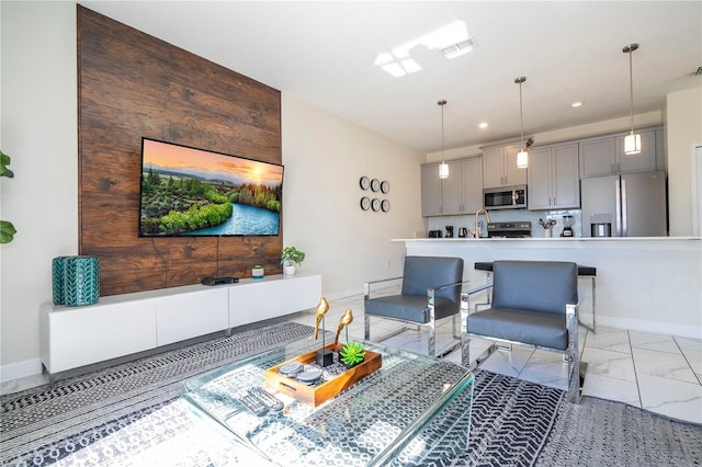 living room featuring baseboards, visible vents, recessed lighting, and marble finish floor