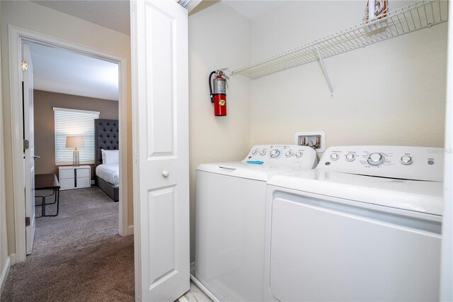 washroom featuring light carpet and washing machine and dryer