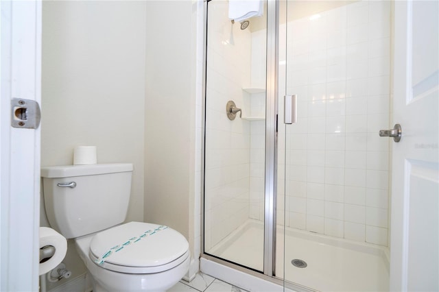 bathroom with a stall shower and toilet