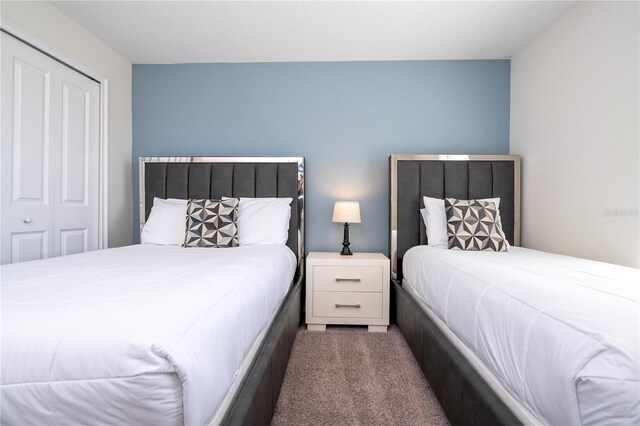 carpeted bedroom with a closet