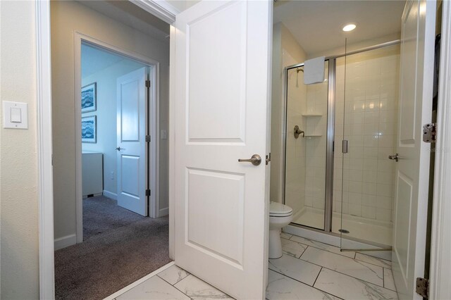 bathroom with toilet and walk in shower