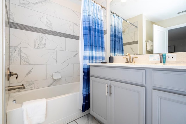 bathroom featuring vanity, visible vents, marble finish floor, and shower / tub combo