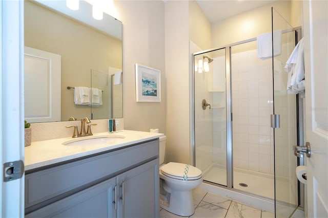 bathroom featuring vanity, toilet, marble finish floor, and a stall shower
