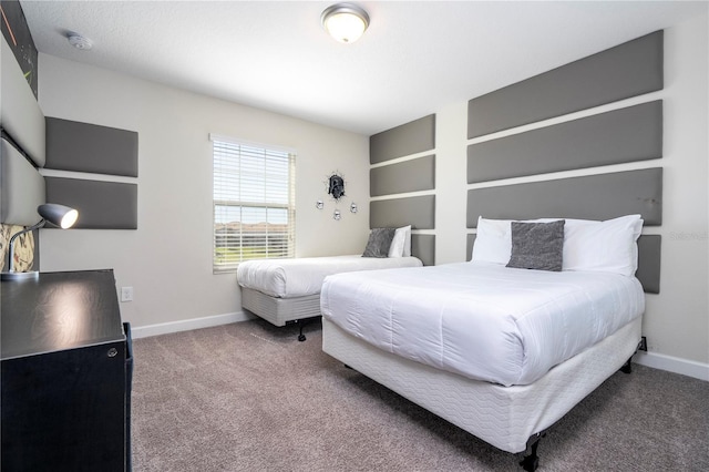 carpeted bedroom featuring baseboards