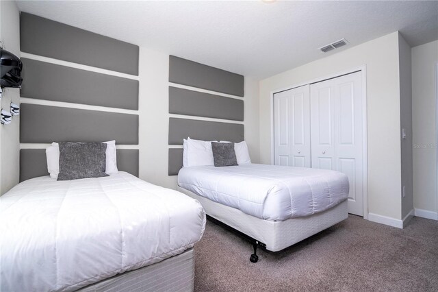 carpeted bedroom featuring a closet