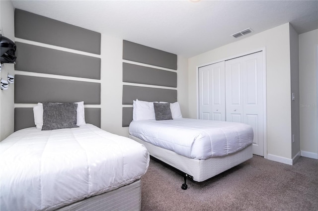 carpeted bedroom with baseboards, visible vents, and a closet