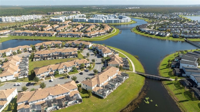 birds eye view of property with a water view and a residential view