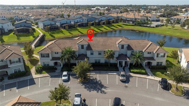 birds eye view of property with a water view and a residential view