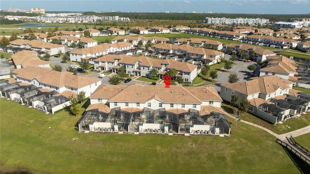 drone / aerial view featuring a residential view and a water view