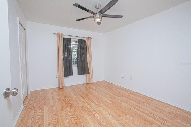 spare room featuring light wood-type flooring and ceiling fan