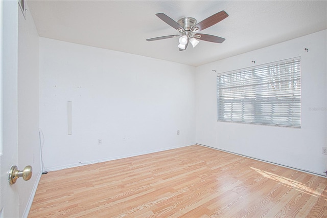 spare room with light hardwood / wood-style floors and ceiling fan