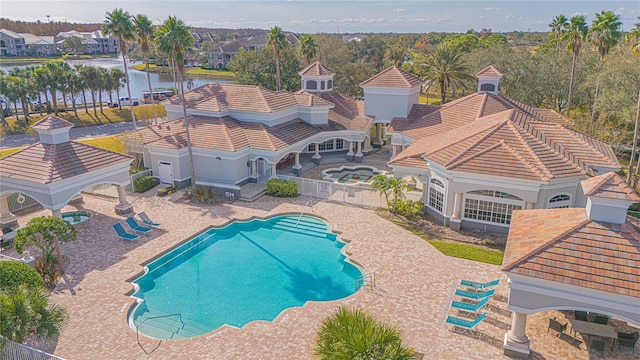 view of pool featuring a gazebo, a water view, and a patio