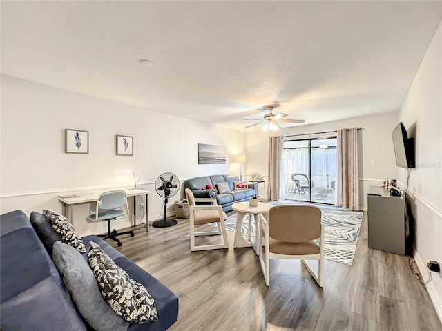 living room with hardwood / wood-style floors and ceiling fan