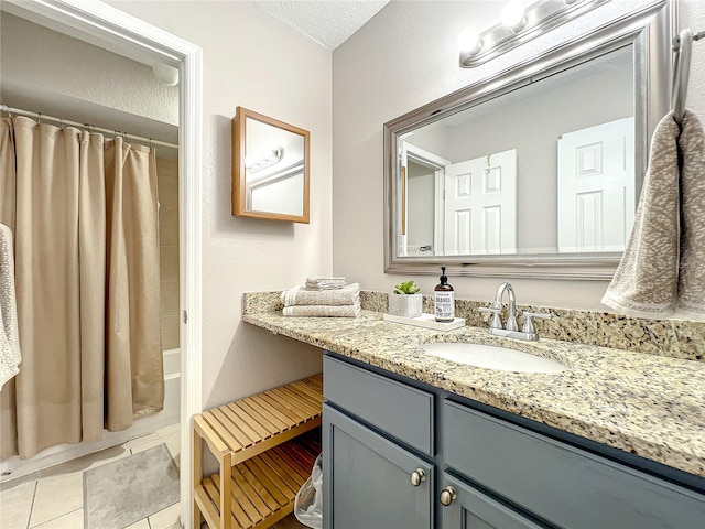 bathroom with vanity, tile patterned floors, a textured ceiling, and shower / bath combo