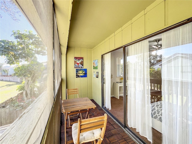 sunroom / solarium with ceiling fan and a wealth of natural light