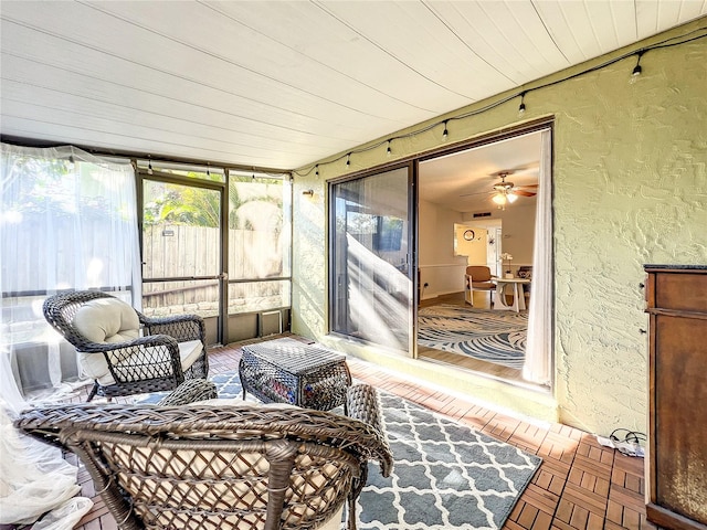 sunroom / solarium featuring wood ceiling and ceiling fan