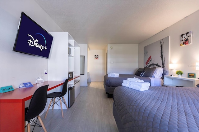 bedroom featuring hardwood / wood-style flooring and a textured ceiling