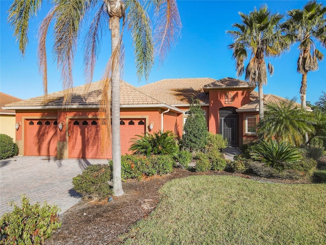 view of front of property featuring a garage and a front yard