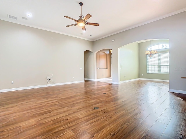 unfurnished room with wood-type flooring, ceiling fan with notable chandelier, and crown molding