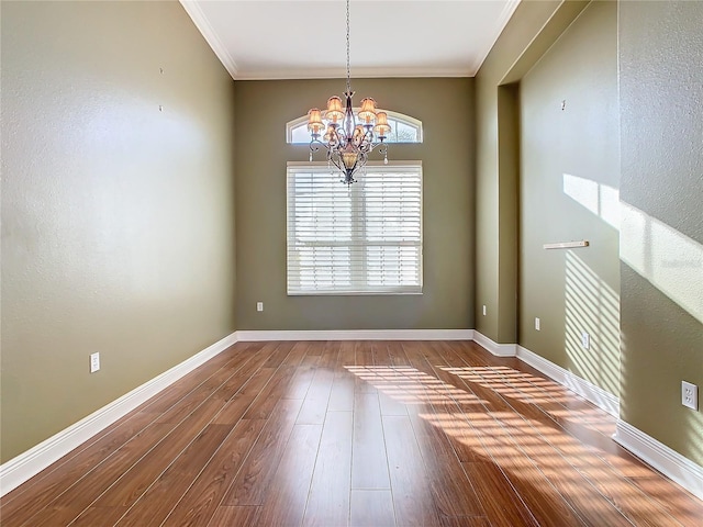 unfurnished room featuring a chandelier, wood-type flooring, and crown molding