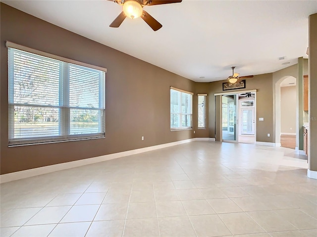 tiled spare room with ceiling fan