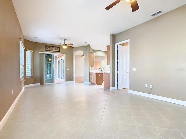 unfurnished living room with ceiling fan and light tile patterned floors