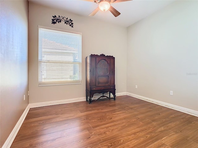 spare room with ceiling fan and dark wood-type flooring