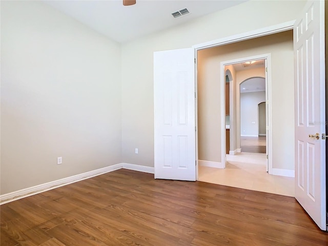 unfurnished room with dark hardwood / wood-style flooring