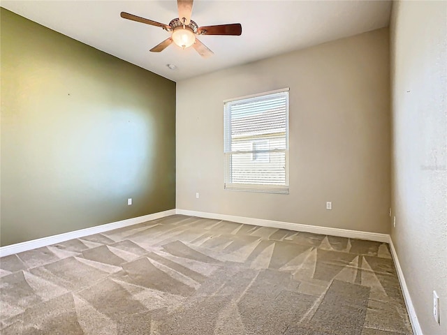 spare room with carpet and ceiling fan