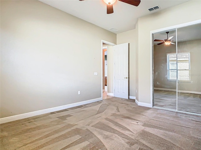 unfurnished bedroom featuring ceiling fan, carpet floors, and a closet