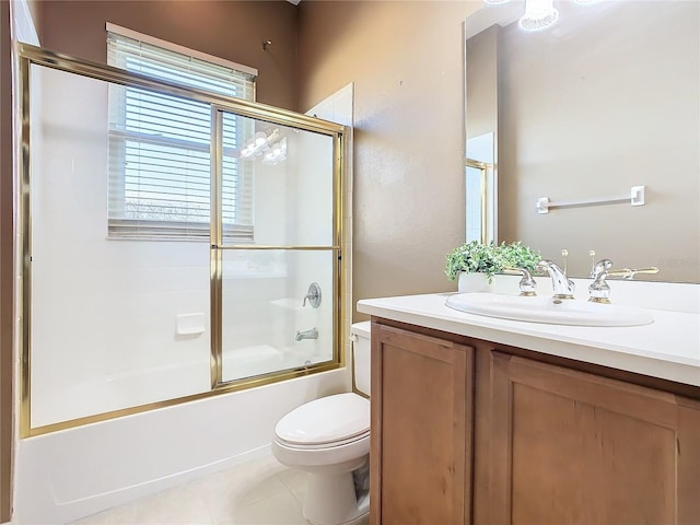 full bathroom featuring tile patterned flooring, vanity, toilet, and bath / shower combo with glass door