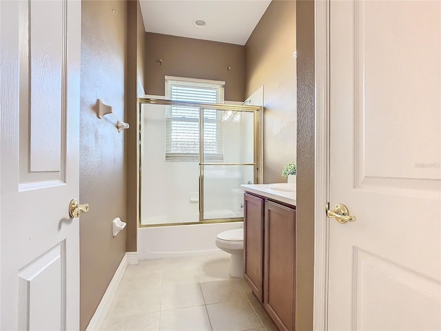 full bathroom with tile patterned floors, vanity, enclosed tub / shower combo, and toilet