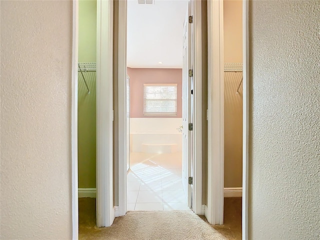 corridor featuring light tile patterned floors