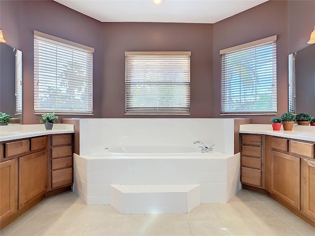 bathroom featuring tile patterned flooring, a bath, and vanity