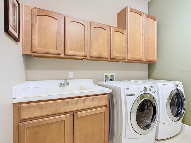 washroom with tile patterned flooring, cabinets, separate washer and dryer, and sink