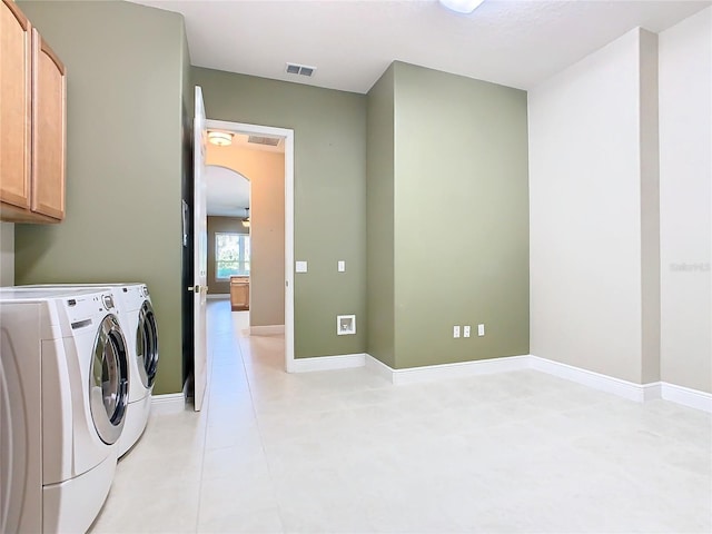 laundry area with cabinets and washing machine and clothes dryer