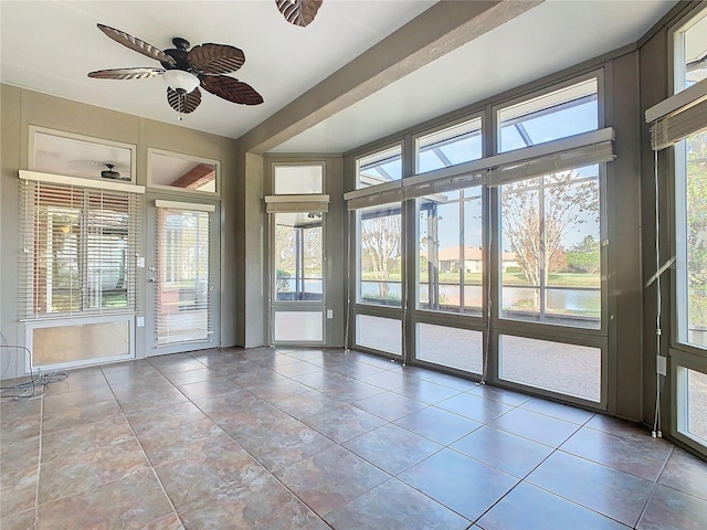 unfurnished sunroom with ceiling fan