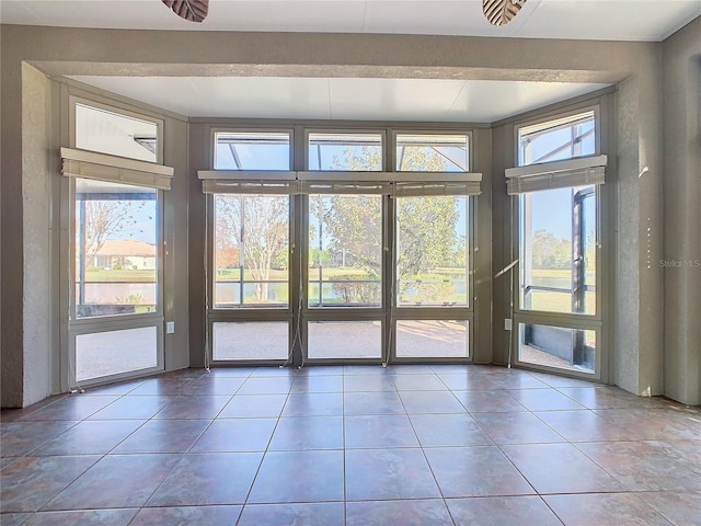 doorway to outside featuring tile patterned flooring