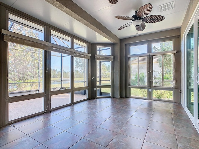 unfurnished sunroom with ceiling fan and a healthy amount of sunlight