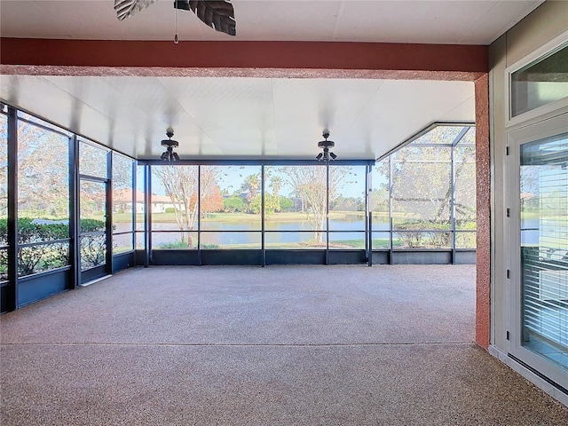 unfurnished sunroom featuring ceiling fan