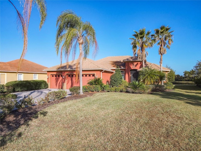 view of front of home with a garage and a front yard