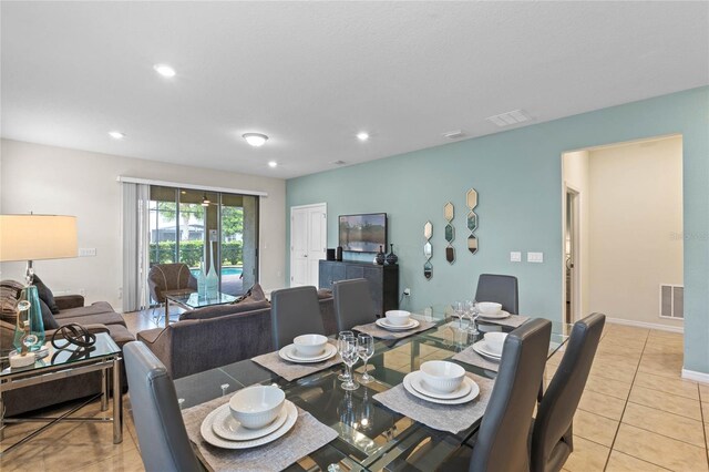 dining space featuring light tile patterned floors