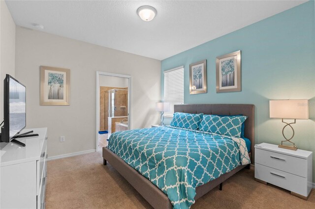 carpeted bedroom with ensuite bathroom