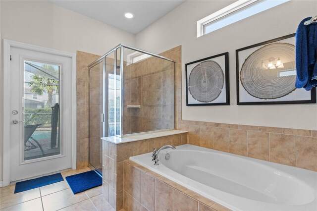 bathroom with separate shower and tub and tile patterned flooring