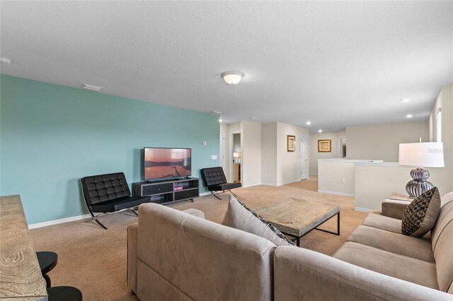 carpeted living room featuring a textured ceiling