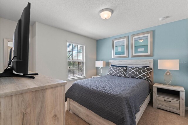 carpeted bedroom with a textured ceiling