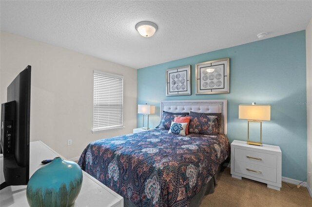 carpeted bedroom featuring a textured ceiling