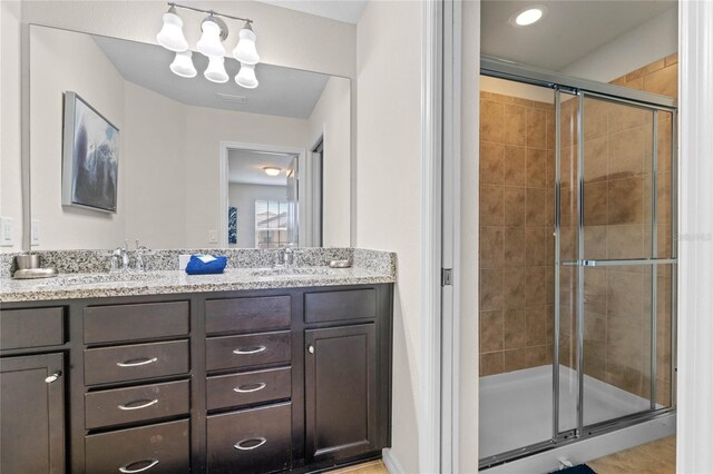 bathroom featuring vanity and an enclosed shower