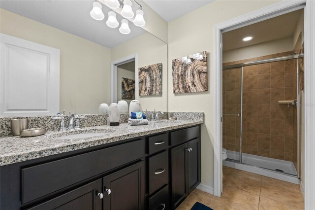 bathroom with vanity, tile patterned floors, toilet, and walk in shower