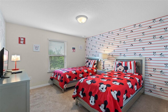 bedroom with light carpet and a textured ceiling